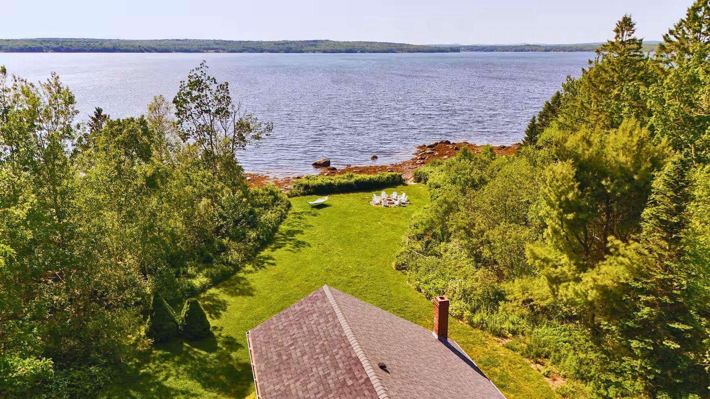 Summer lawn running down to the rocky shore at Eagles Nest