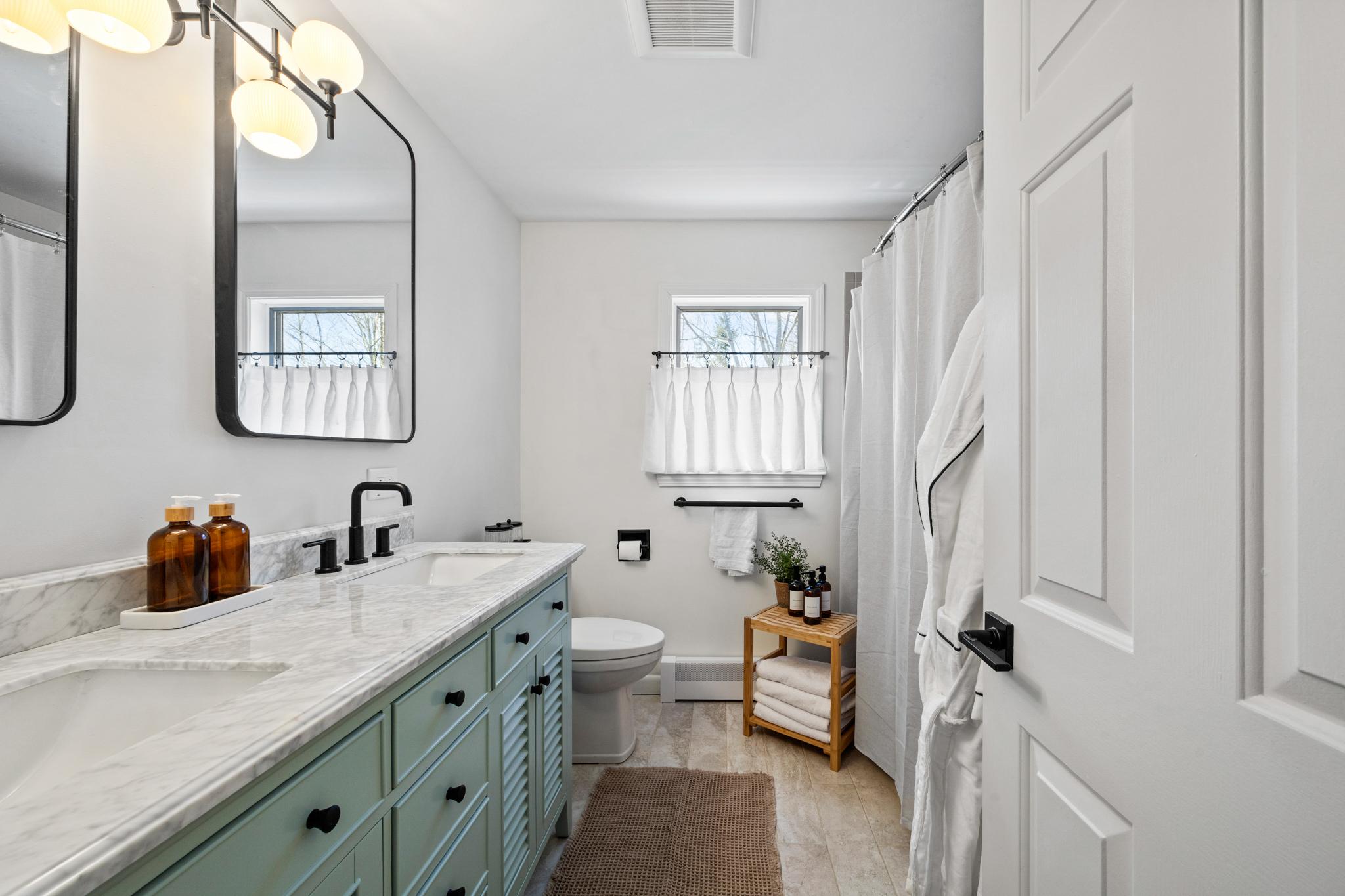Sage bathroom with a double vanity at Eagles Nest