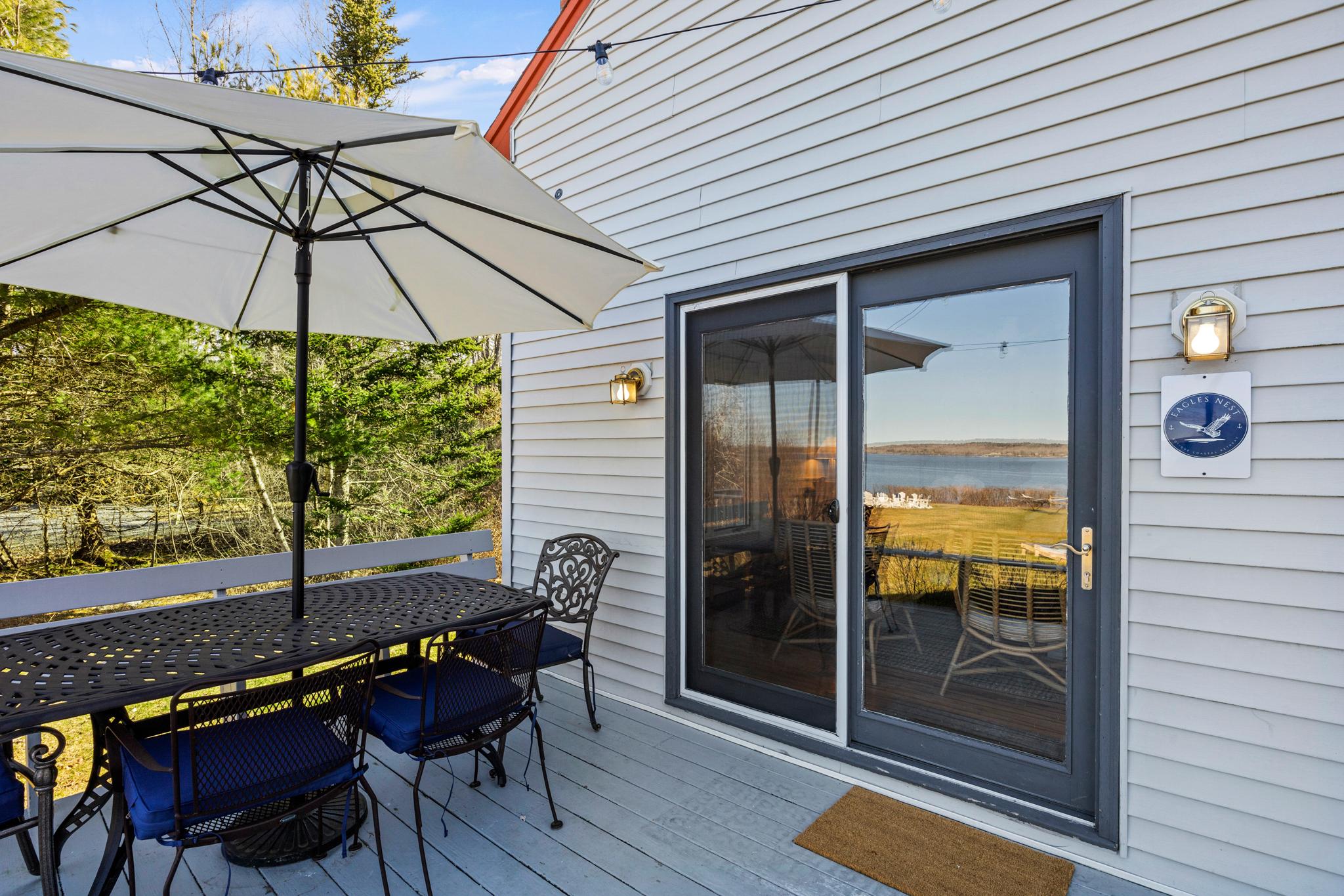 Outdoor dining on the deck at Eagles Nest overlooking the bay