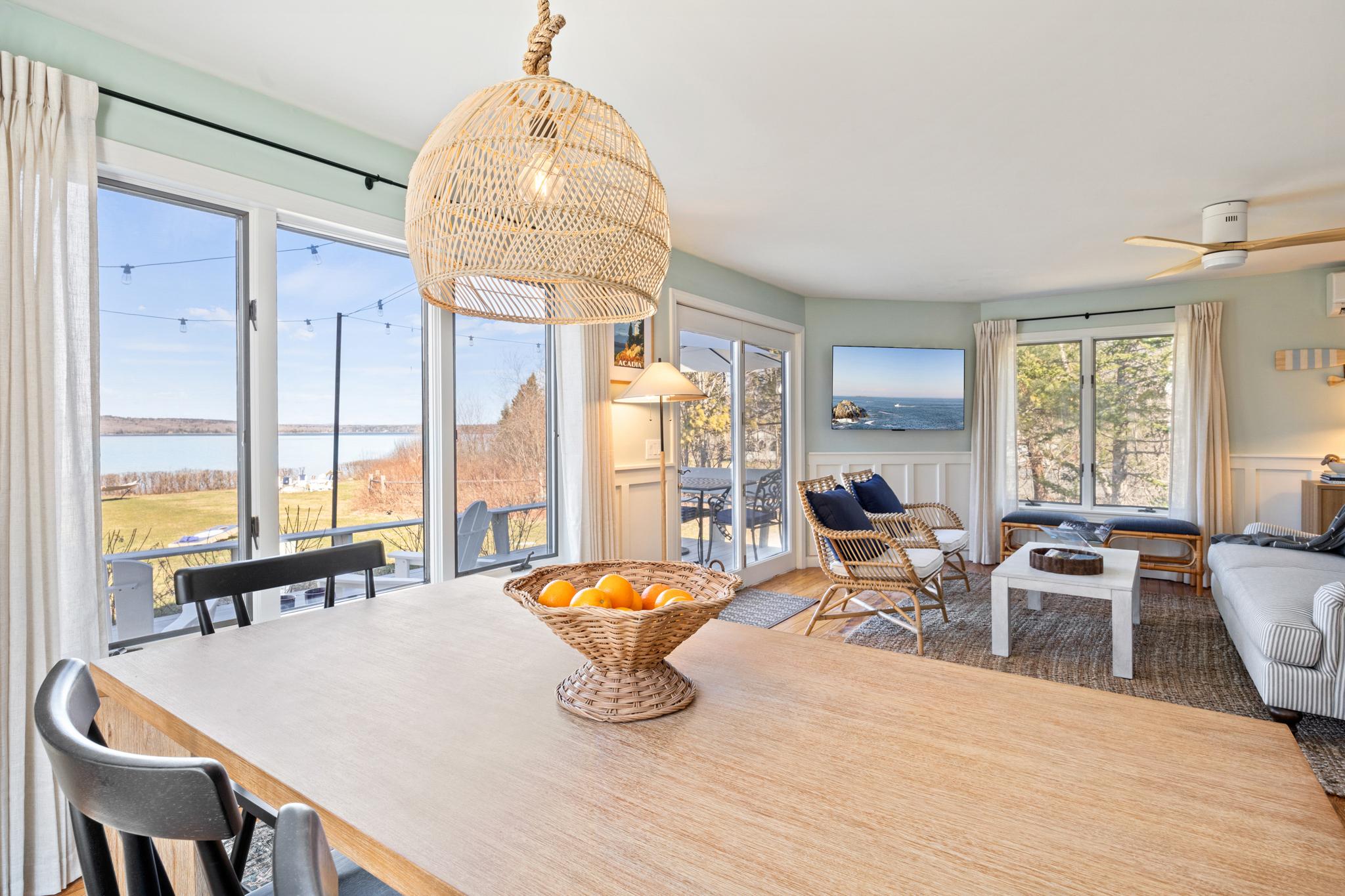 Long dining table by the window with bay views at Eagles Nest