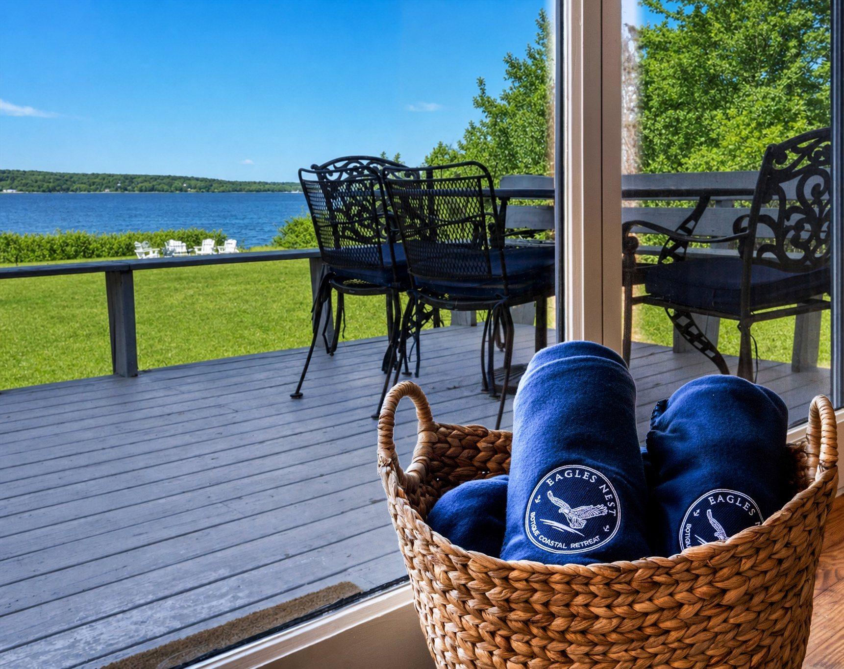 Deck with branded blankets overlooking the bay at Eagles Nest