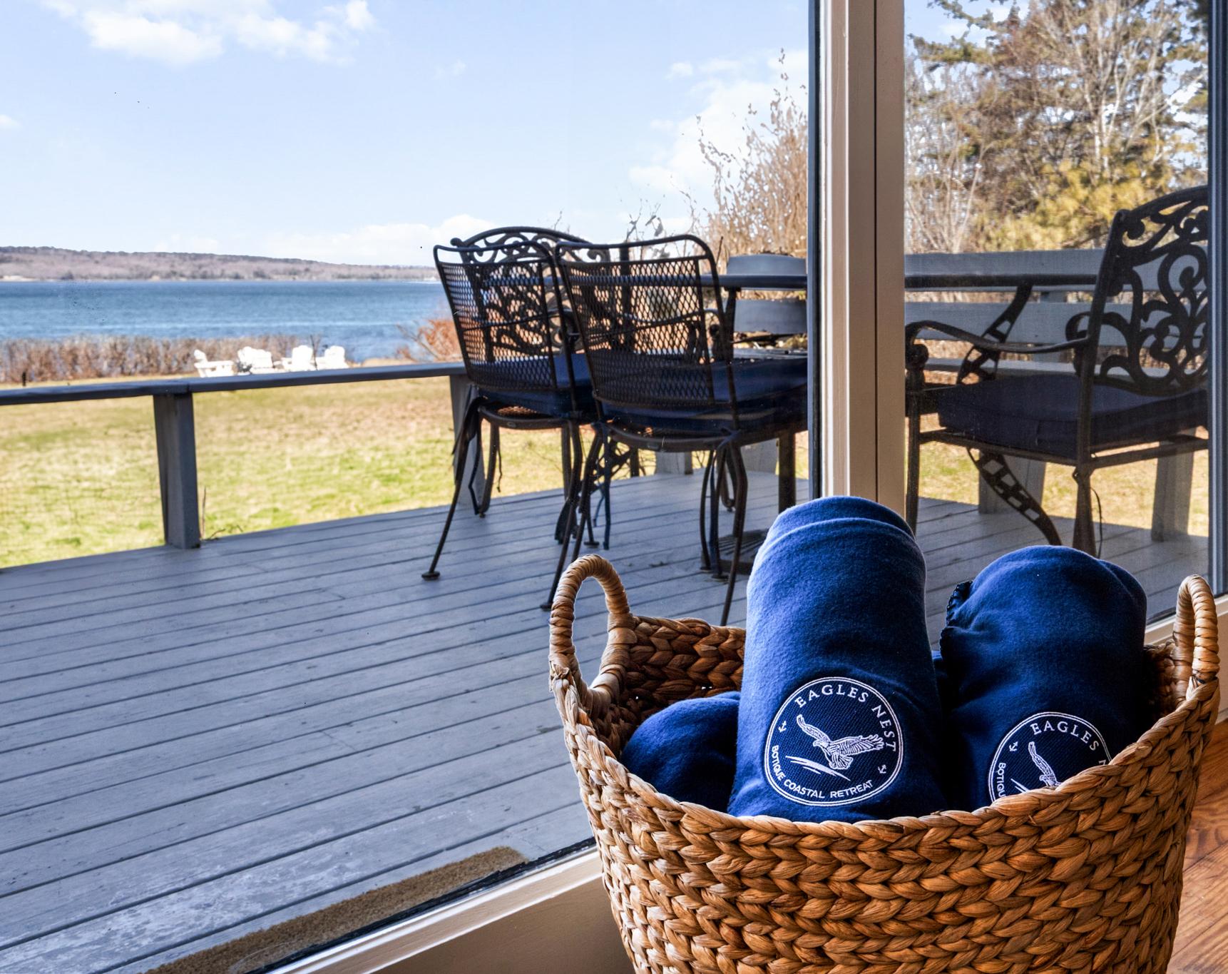 Deck with branded blankets overlooking the bay at Eagles Nest