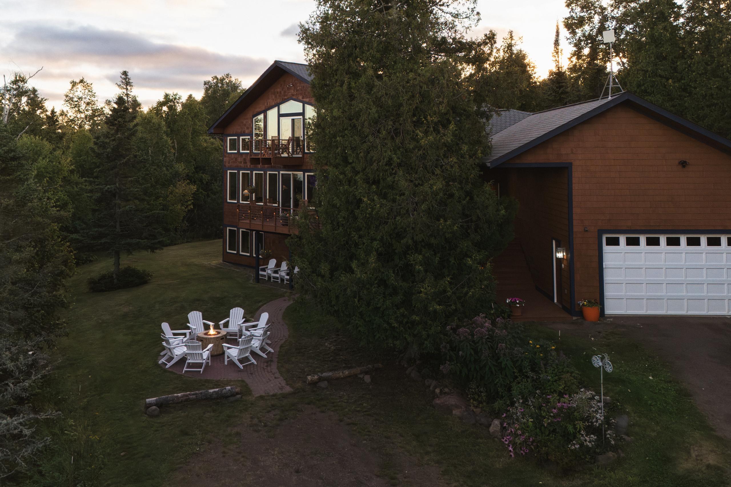 Aerial view of the lakeside fire pit and yard at Nordhus Lodge