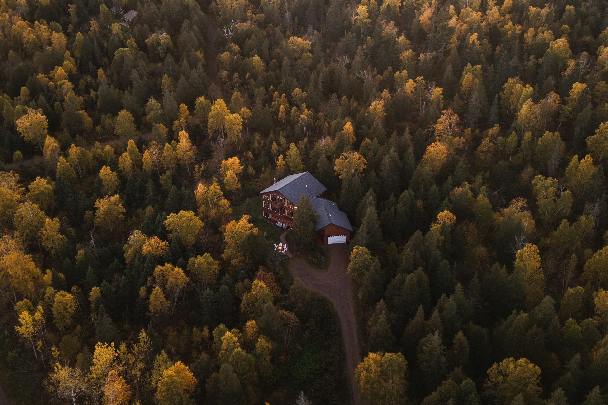 Aerial of Nordhus Lodge amid peak fall foliage above Lake Superior