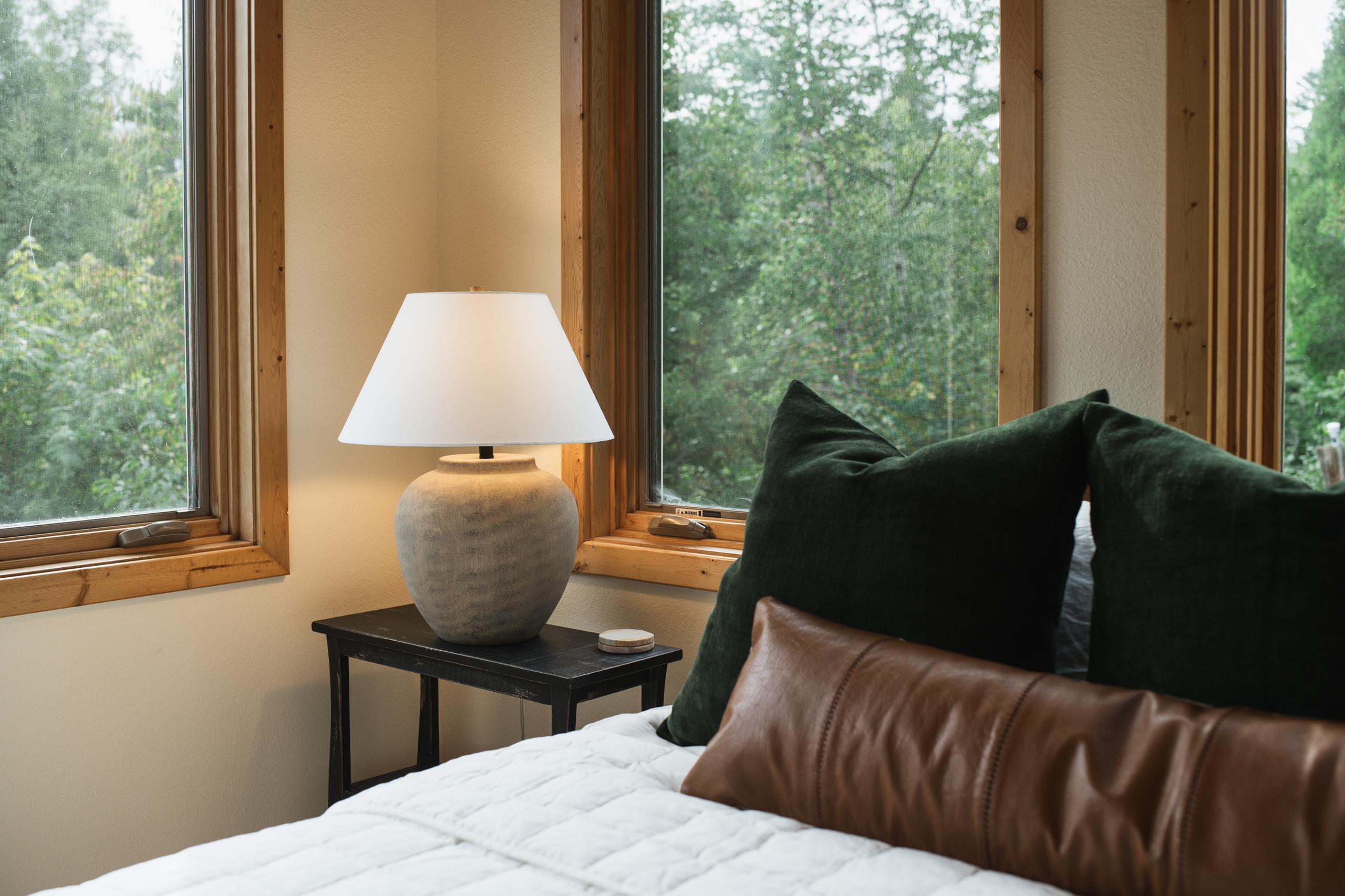 King bedroom with forest views at Nordhus Lodge