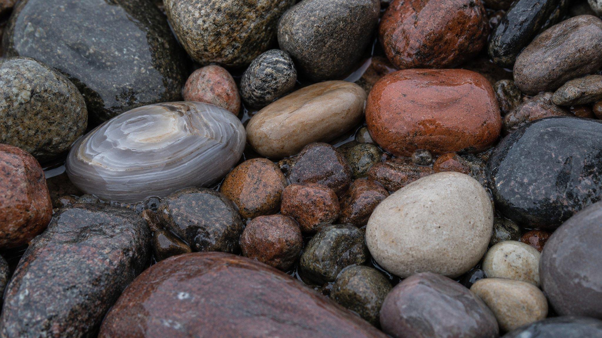 Wet banded agates and cobbles on a Lake Superior shoreline