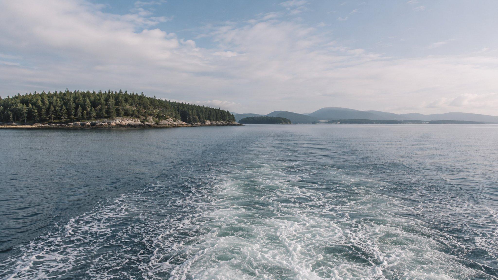 The wake of a passenger ferry crossing between islands off the Maine coast