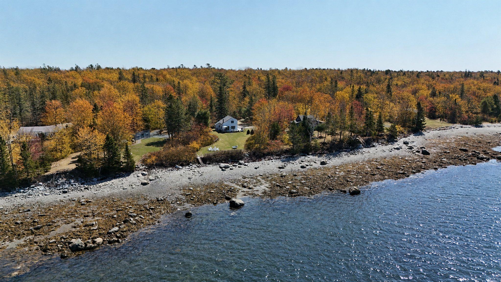 Aerial view over Eagles Nest and its rocky shoreline at peak autumn color