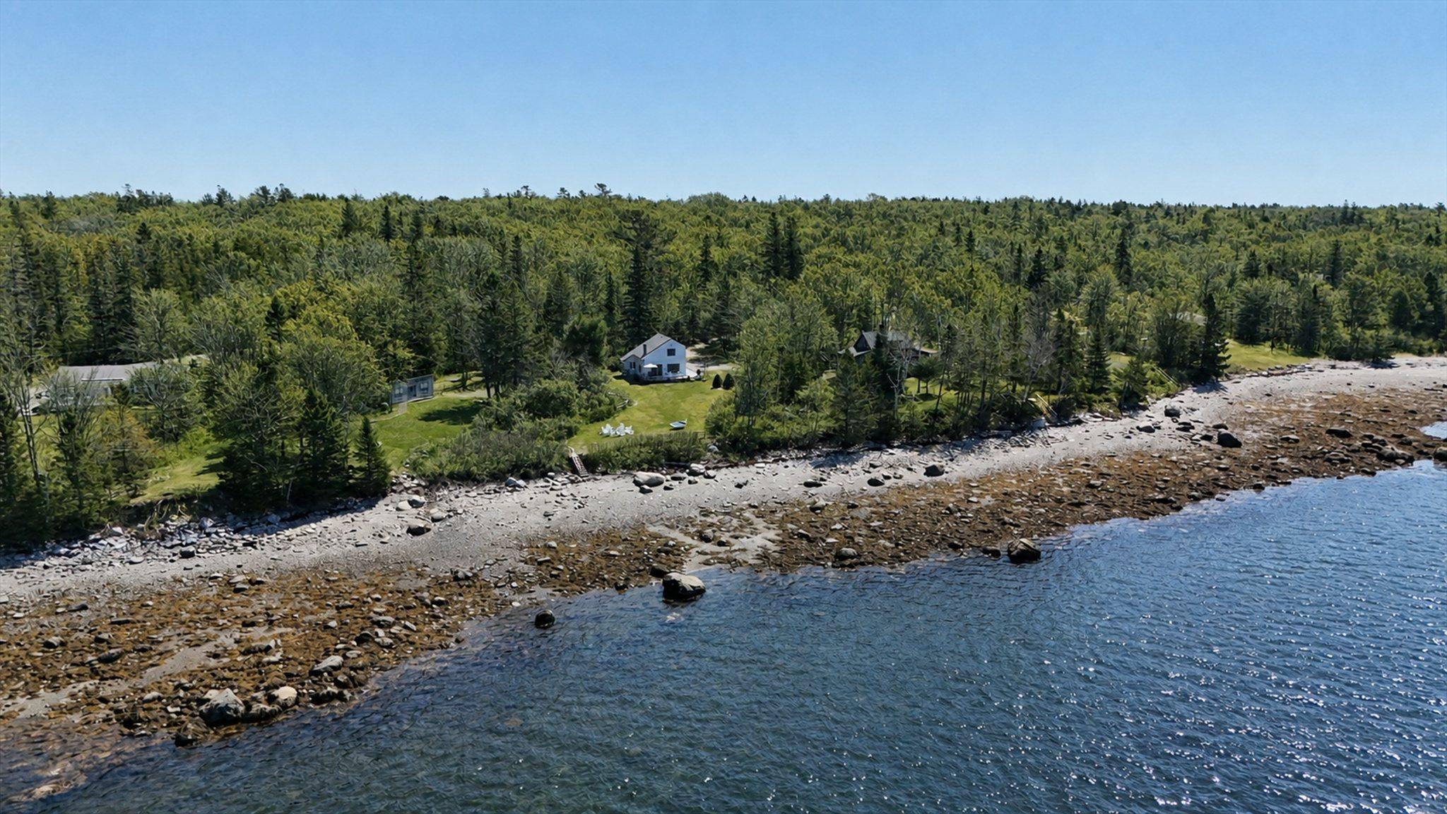 Aerial view of Eagles Nest above its private rocky shoreline on the Maine coast near Acadia